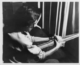 Anni Albers, Photograph of Anni Albers card weaving at Black Mountain College. Anni Albers taught Weaving and Textile Design at Black Mountain College from 1933-1949. Courtesy The North Carolina State Archives.