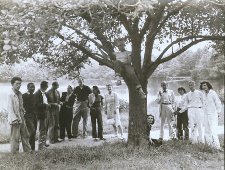 Summer Arts Institute Faculty, Black Mountain College, 1946. Left to right: Leo Amino, Jacob Lawrence, Leo Lionni, Ted Dreier, Nora Lionni, Beaumont Newhall, Gwendolyn Lawrence, Ise Gropius, Jean Varda (in tree), Nancy Newhall (sitting), Walter Gropius, Mary "Molly" Gregory, Josef Albers, Anni Albers. Courtesy of Western Regional Archives.