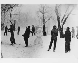Snowball fight, Lake Eden campus, Black Mountain College, ca. early 1940s. On back of the photograph: "Jane Slater, standing to right of snow man." Photographer is identified as John Campbell. Courtesy of Western Regional Archives.