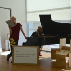 Photo by Elizabet Damyanova. Tobias Shaw Petersen reading while Desiree Vaksdal plays the piano.